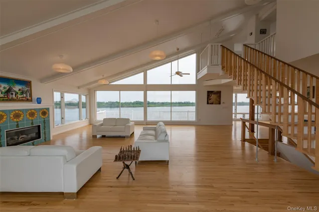 a living room with fireplace furniture and a large window