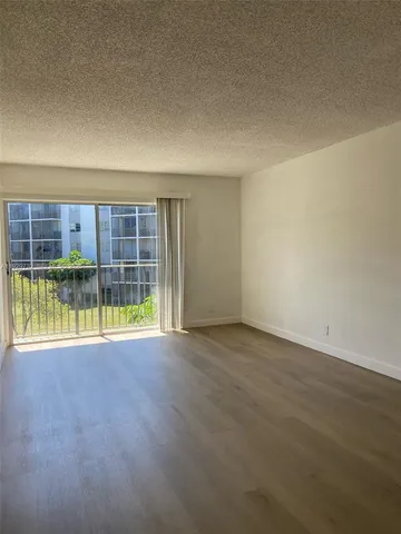 an empty room with a empty space and glass door