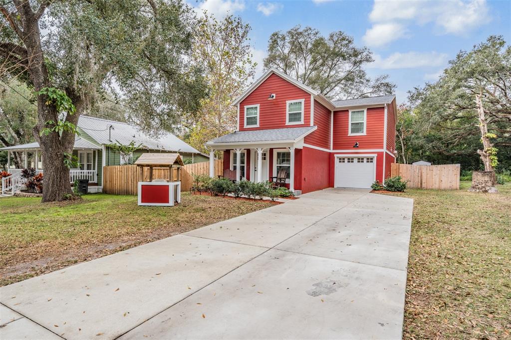 17415 Sweetwater Road Dade City, FL 33523 - Photo 25 of 72 a front view of a house with a yard and garage