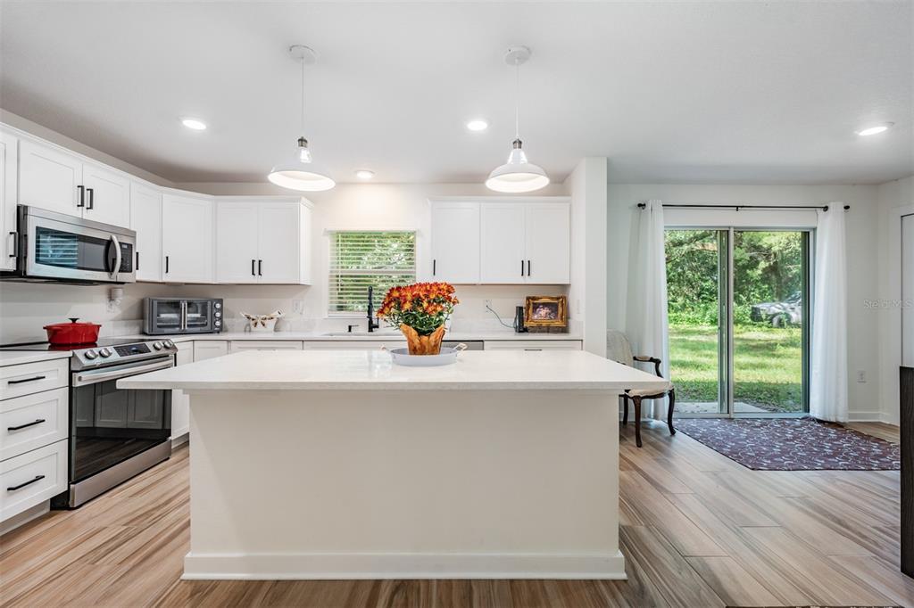 17415 Sweetwater Road Dade City, FL 33523 - Photo 4 of 72 a view of kitchen with sink and microwave