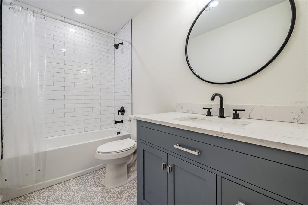 17415 Sweetwater Road Dade City, FL 33523 - Photo 42 of 72 a bathroom with a sink a toilet and a mirror