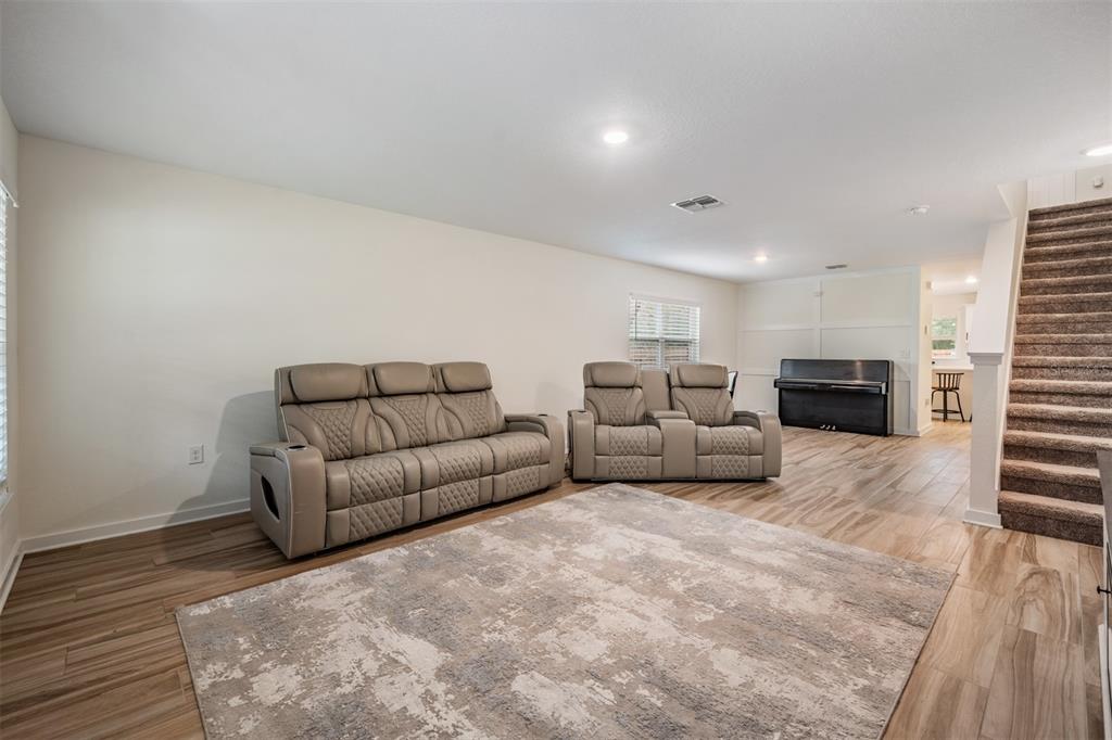17415 Sweetwater Road Dade City, FL 33523 - Photo 56 of 72 a living room with furniture a flat screen tv and a fireplace