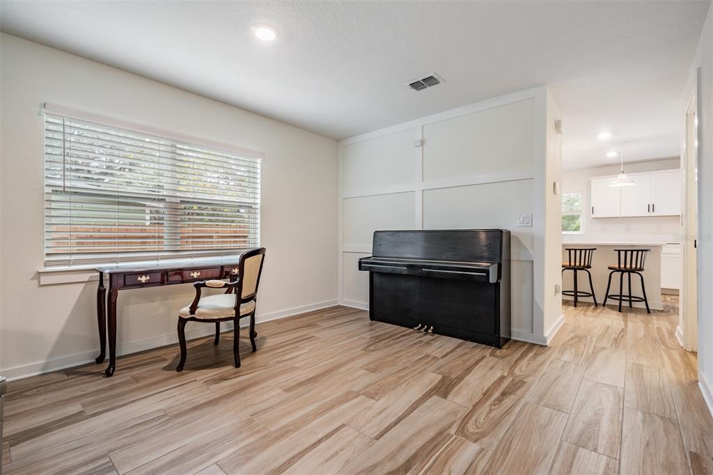 17415 Sweetwater Road Dade City, FL 33523 - Photo 57 of 72 a kitchen with a table chairs and a wooden floor