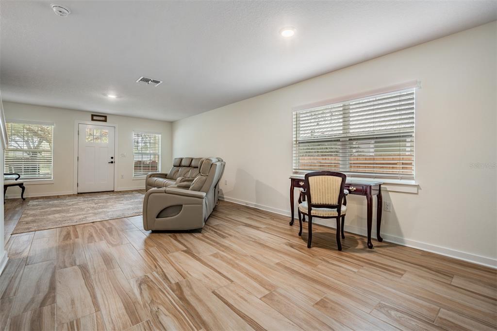 17415 Sweetwater Road Dade City, FL 33523 - Photo 58 of 72 a living room with furniture and a wooden floor