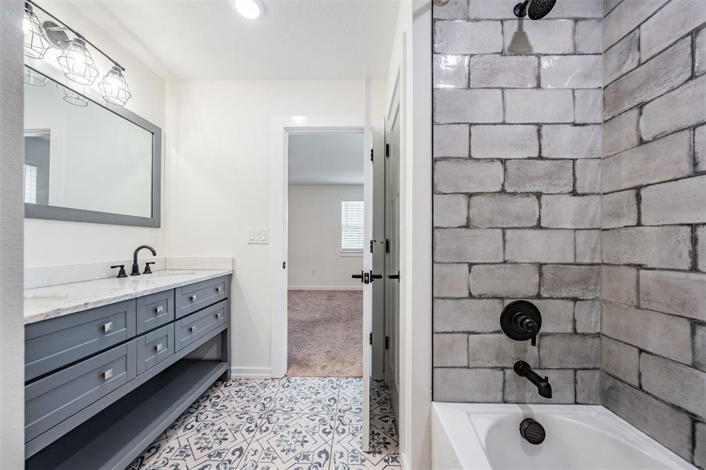 17415 Sweetwater Road Dade City, FL 33523 - Photo 61 of 72 a bathroom with a sink and a tub