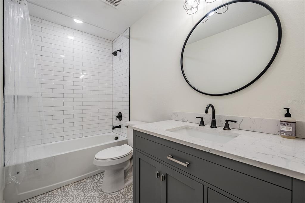 17415 Sweetwater Road Dade City, FL 33523 - Photo 63 of 72 a bathroom with a sink a toilet and a mirror