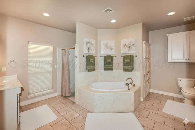 a bathroom with a toilet a sink and bathtub