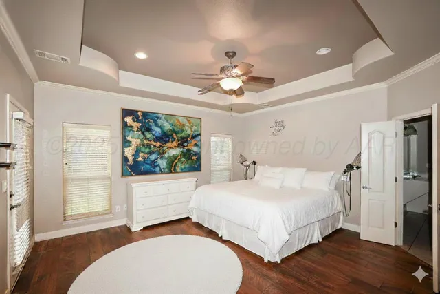 a bedroom with a bed and a painting on the wall