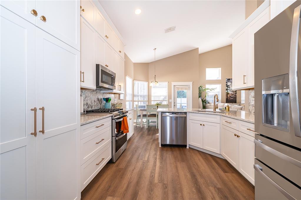 758 Seneca Meadows Road Winter Springs, FL 32708 - Photo 15 of 37 a kitchen with granite countertop a refrigerator stove top oven and sink