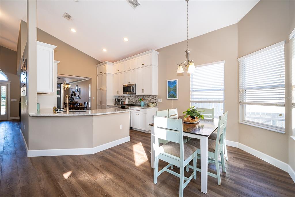 758 Seneca Meadows Road Winter Springs, FL 32708 - Photo 18 of 37 a kitchen with white cabinets and wooden floor
