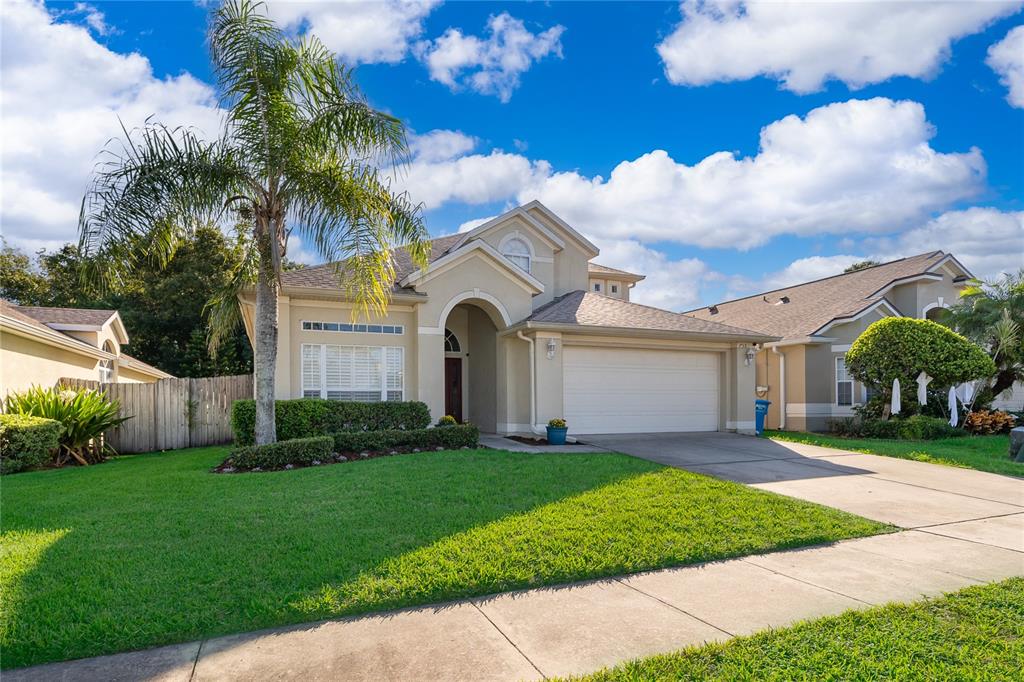 758 Seneca Meadows Road Winter Springs, FL 32708 - Photo 3 of 37 a view of a white house with a big yard and potted plants