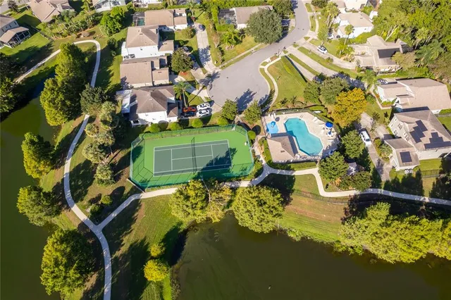 an aerial view of a house with a yard swimming pool and outdoor seating