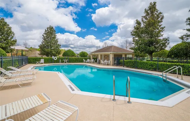 a view of a swimming pool with a patio