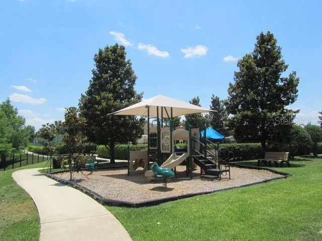 a view of a park with sitting area and furniture