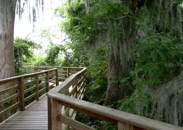 a view of balcony with wooden floor and fence