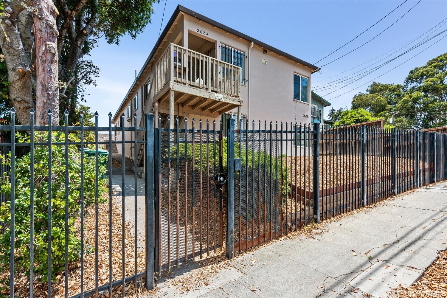 a view of a house with iron fence