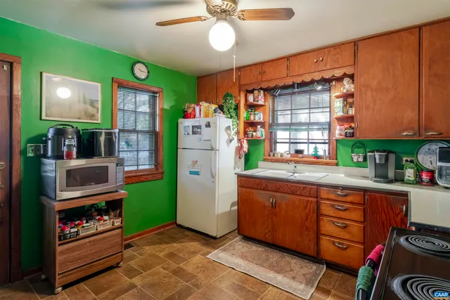 a kitchen with refrigerator and window