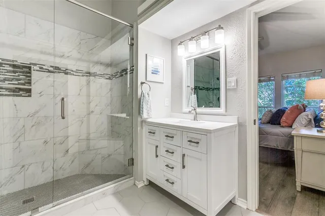 a bathroom with a shower sink and mirror