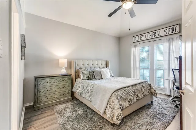 a bedroom with a bed and large mirror