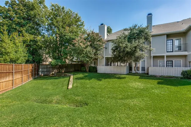 a garden with trees in front of it