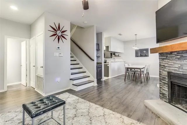 a living room with furniture a fireplace and a flat screen tv