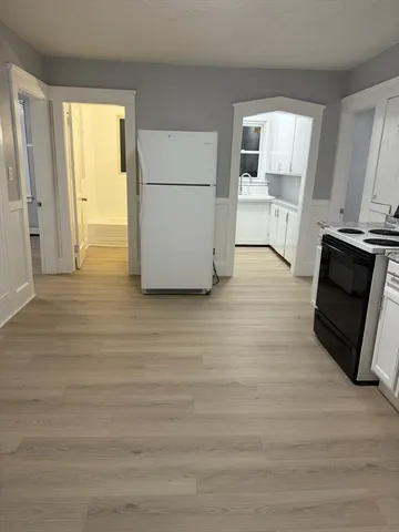 a view of kitchen and wooden floor