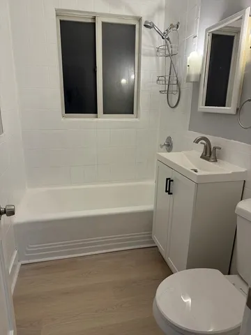 a bathroom with a toilet a sink and mirror