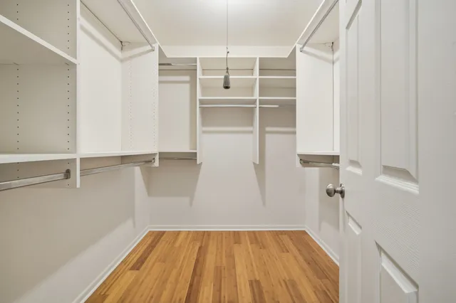 a view of walk in closet with empty racks