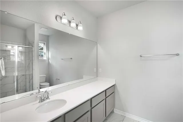 a bathroom with a shower and a glass door