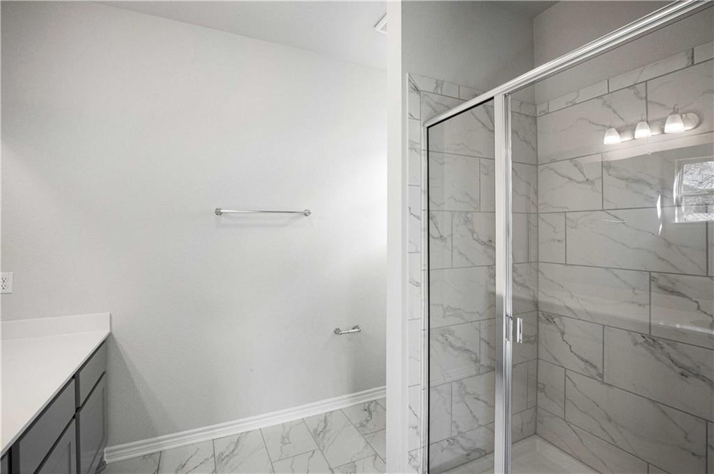 1616 Turtle Bay Loop Leander, TX 78641 - Photo 19 of 33 a bathroom with a shower and a glass door