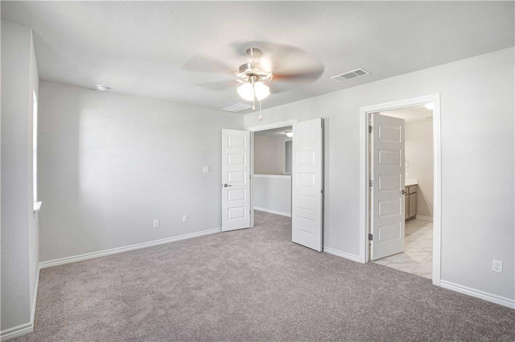 1616 Turtle Bay Loop Leander, TX 78641 - Photo 24 of 33 a view of an empty room and a ceiling fan