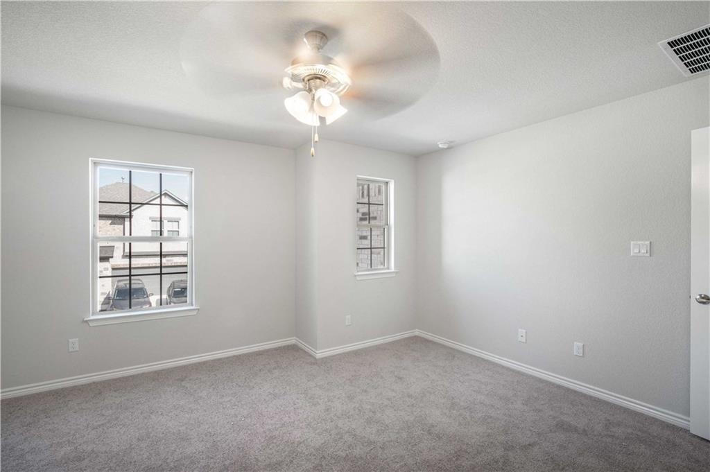 1616 Turtle Bay Loop Leander, TX 78641 - Photo 25 of 33 an empty room with windows and fan