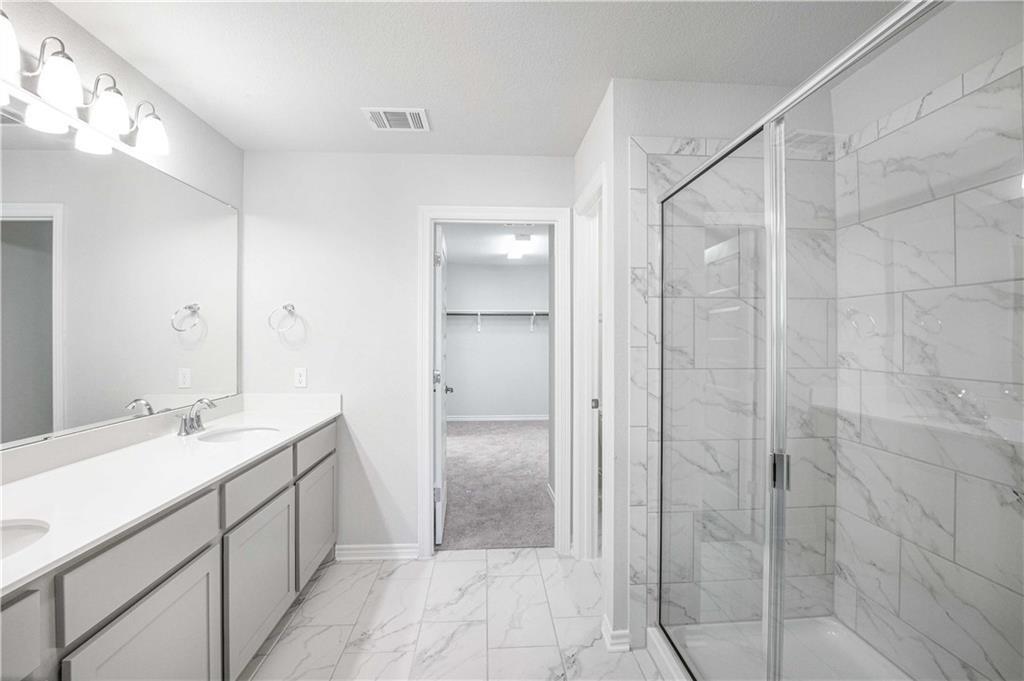 1616 Turtle Bay Loop Leander, TX 78641 - Photo 26 of 33 a spacious bathroom with a shower and a sink
