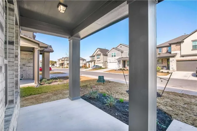 a view of a porch with a floor to ceiling window and yard