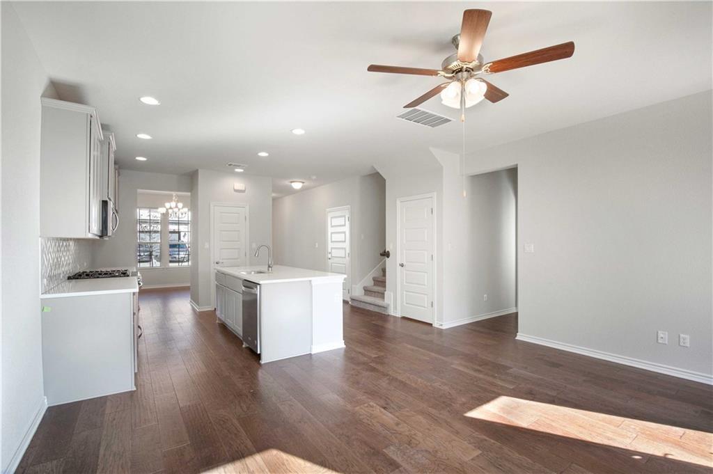 1616 Turtle Bay Loop Leander, TX 78641 - Photo 8 of 33 a open kitchen with white cabinets and white appliances