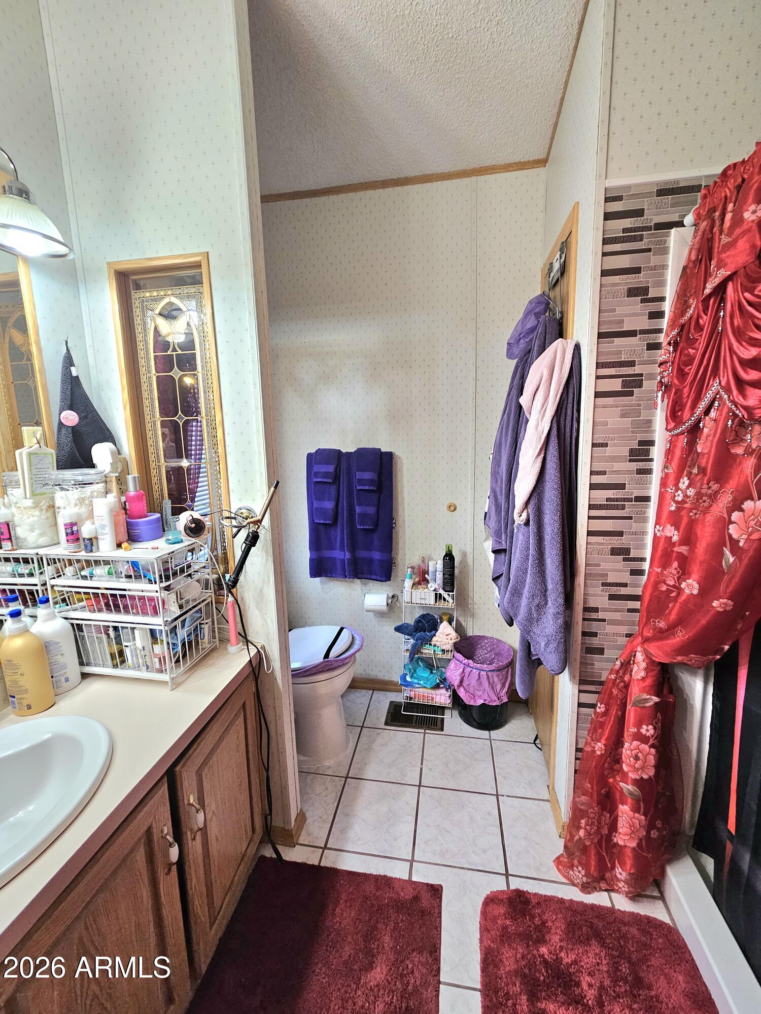 3145 West Citrus Road Benson, AZ 85602 - Photo 19 of 36 a view of walk in closet with clothes and shoes