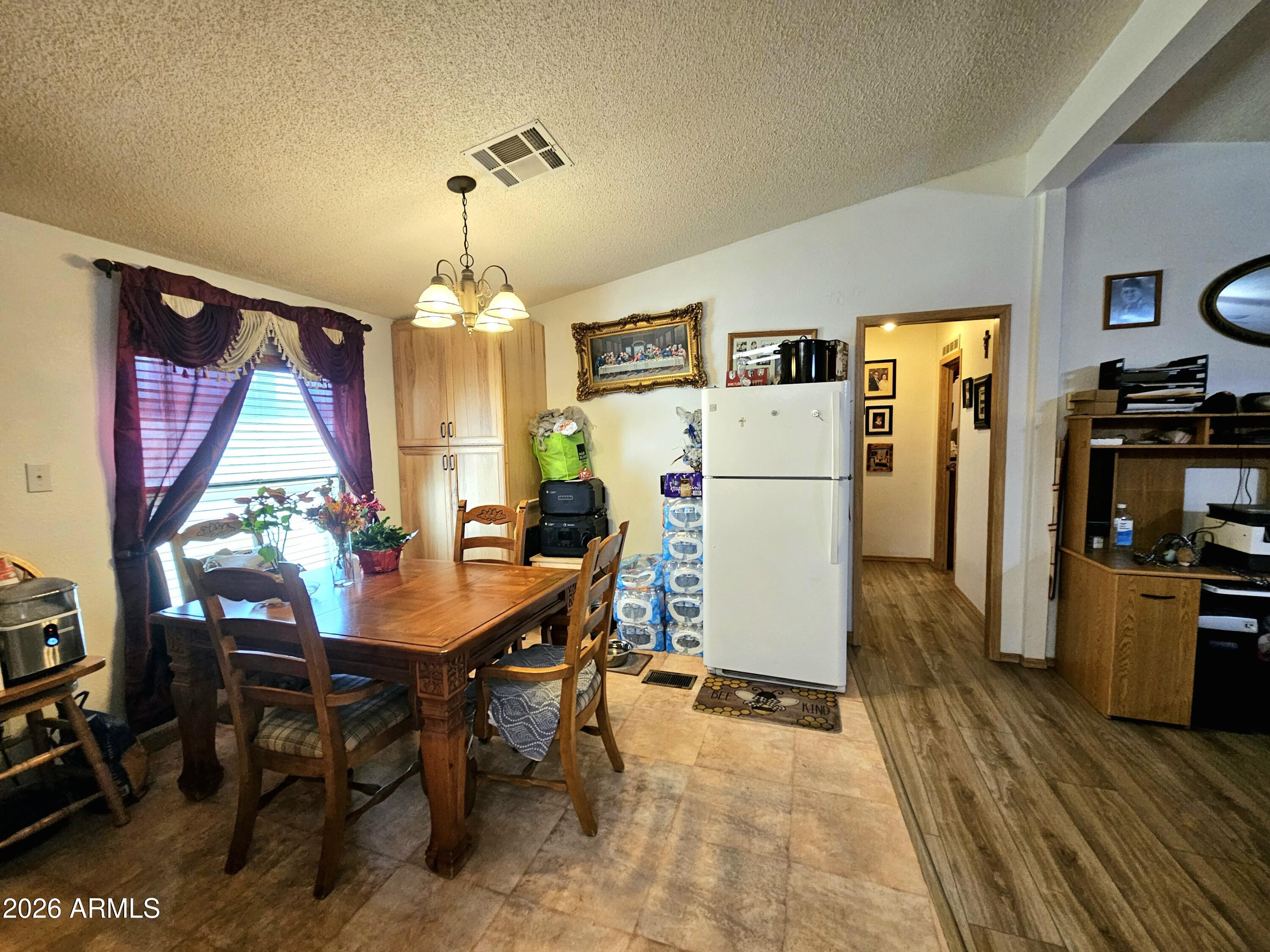 3145 West Citrus Road Benson, AZ 85602 - Photo 26 of 36 a view of a dining room with furniture window and wooden floor
