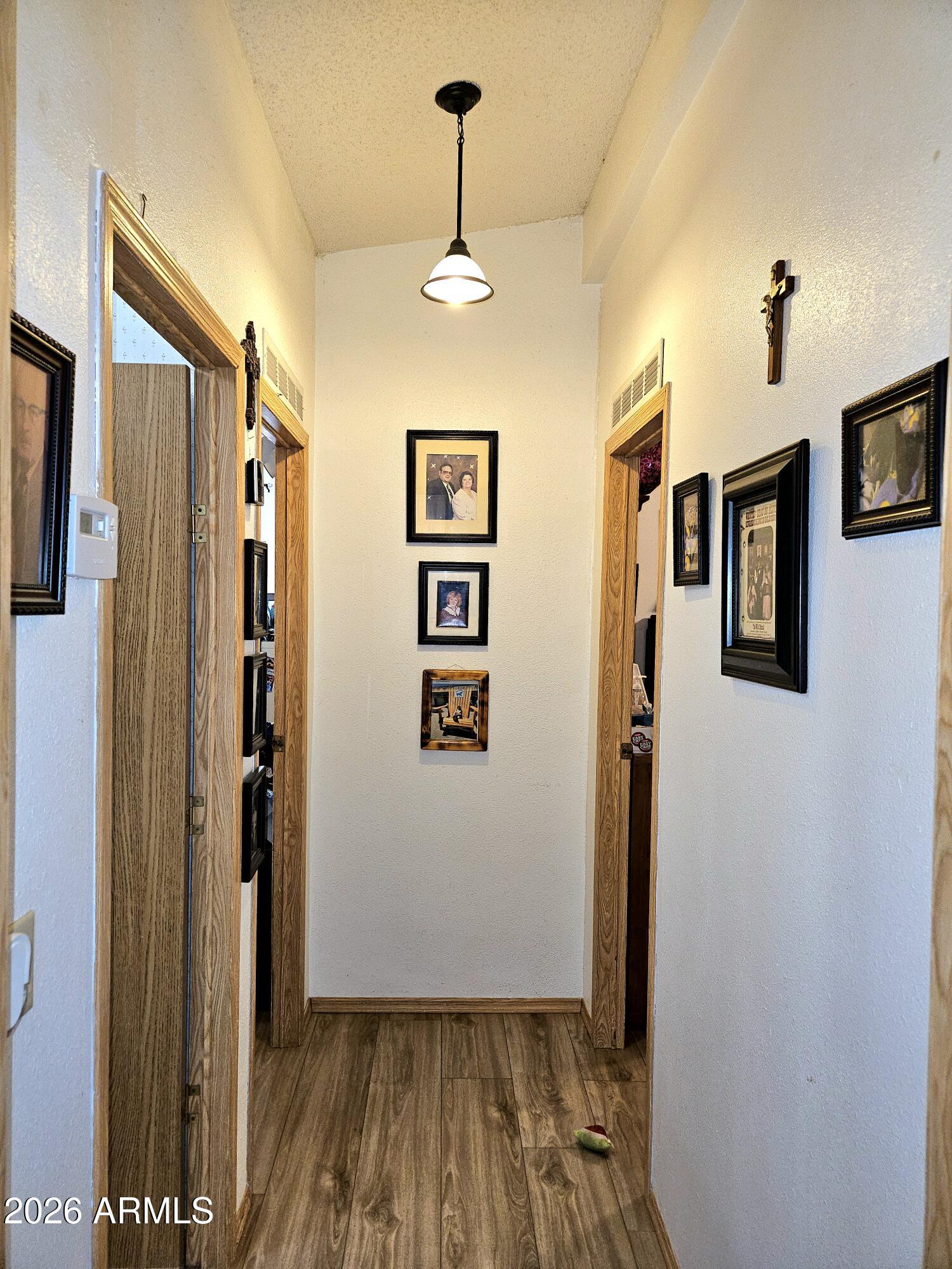 3145 West Citrus Road Benson, AZ 85602 - Photo 27 of 36 a view of a hallway with wooden floor and staircase
