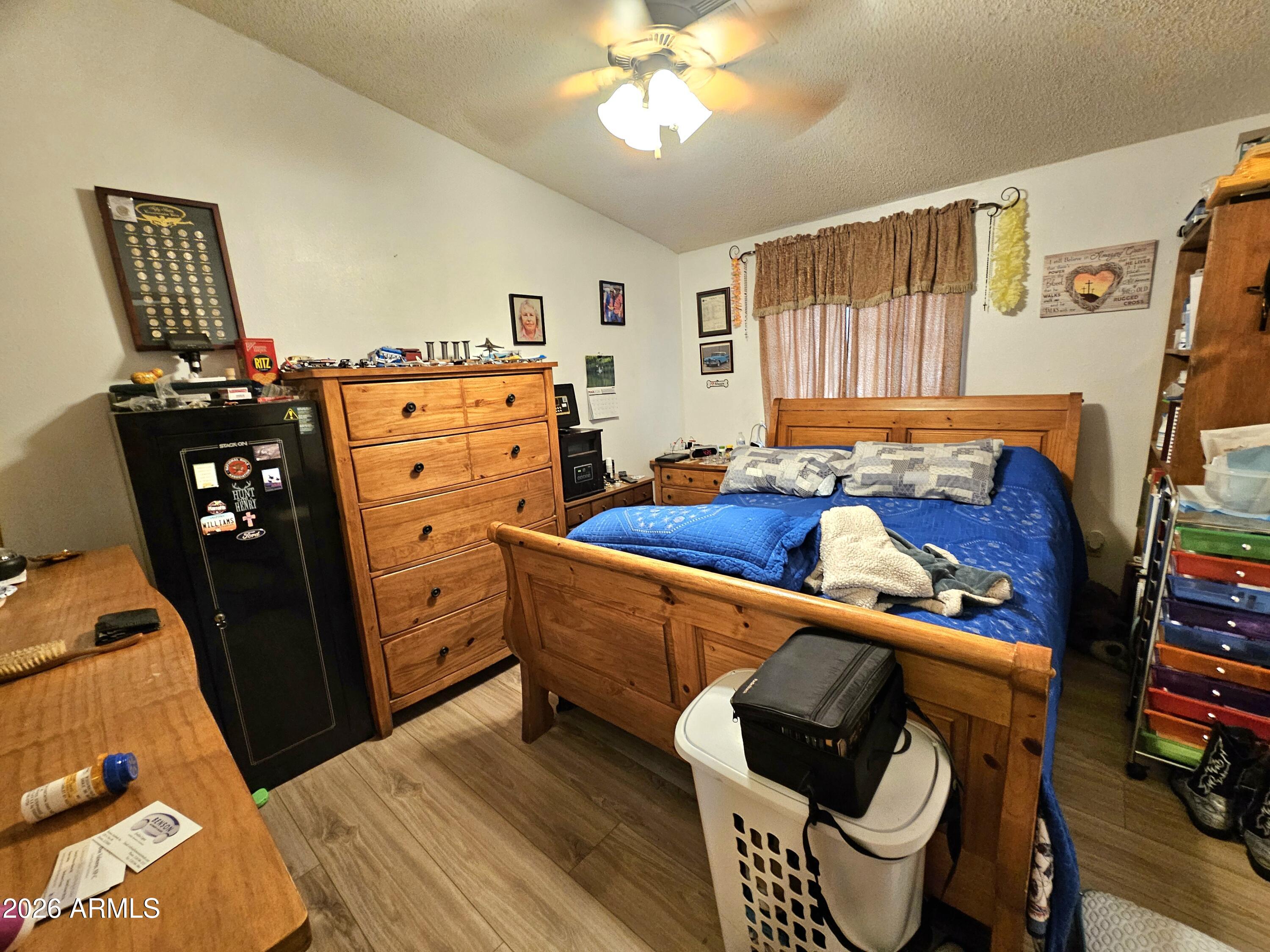 3145 West Citrus Road Benson, AZ 85602 - Photo 28 of 36 a bedroom with furniture and a window