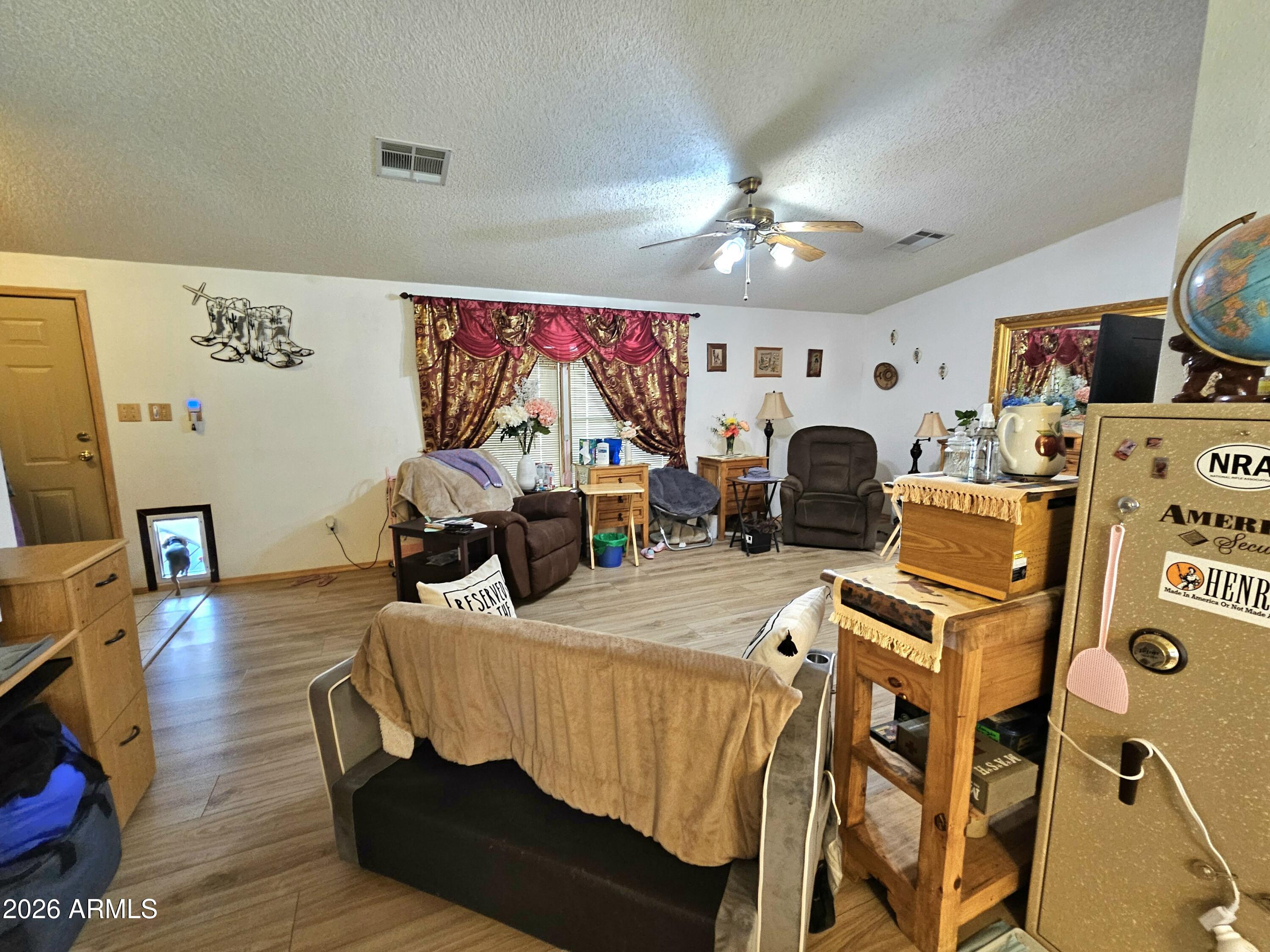 3145 West Citrus Road Benson, AZ 85602 - Photo 29 of 36 a living room with furniture and a flat screen tv
