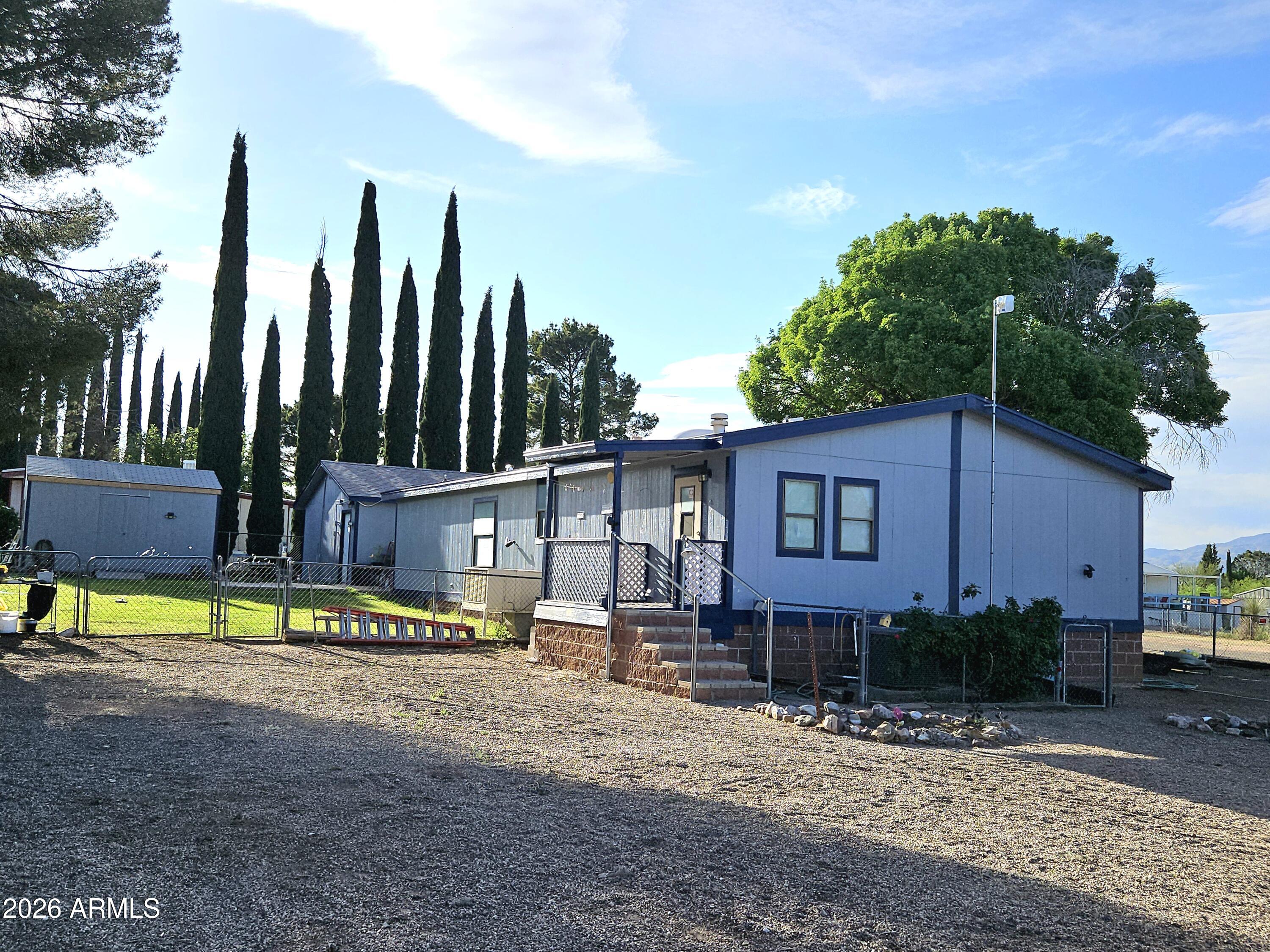 3145 West Citrus Road Benson, AZ 85602 - Photo 9 of 36 a view of a house with backyard and sitting area