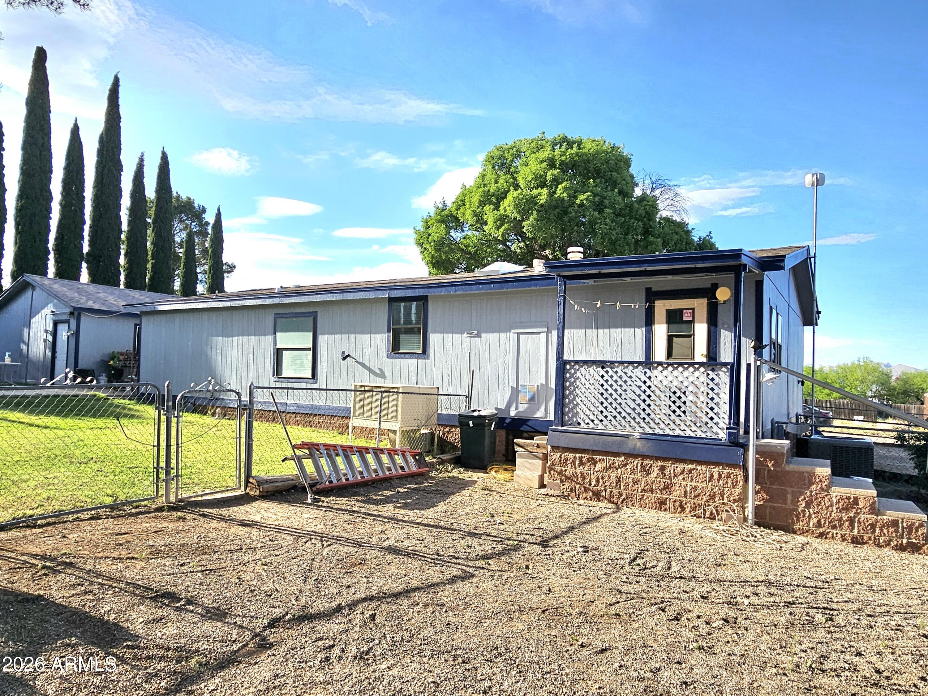 3145 West Citrus Road Benson, AZ 85602 - Photo 10 of 36 a front view of a house with a yard