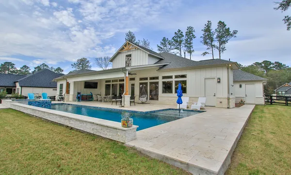a view of a house with swimming pool and sitting area