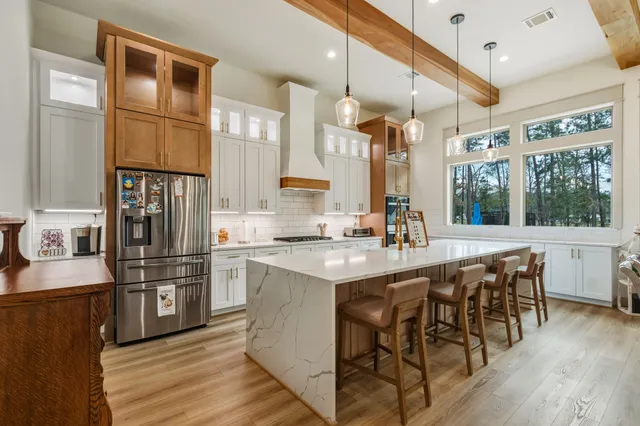 a spacious bedroom with a bed and a dresser