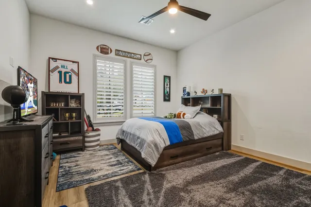 a dining room with furniture and a large window