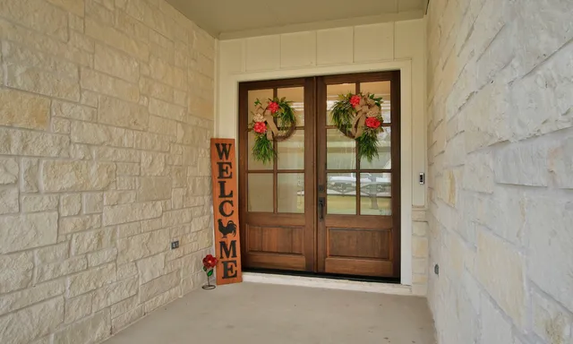 a living room with furniture a large window and a flat screen tv