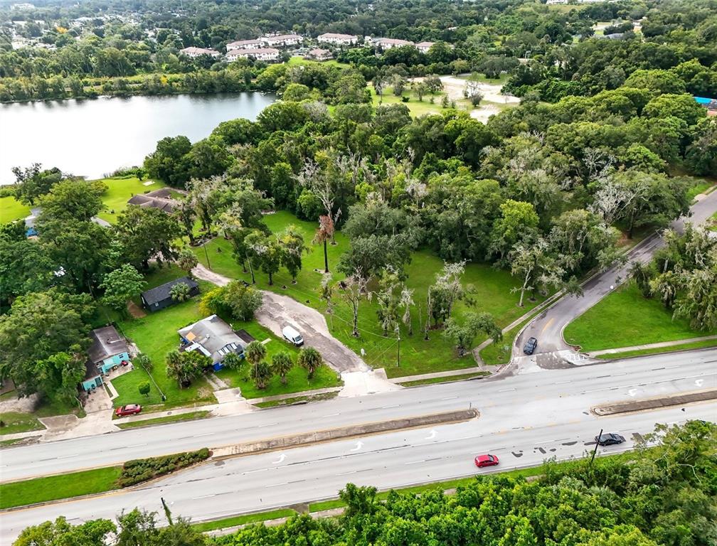 an aerial view of a house with yard and lake view