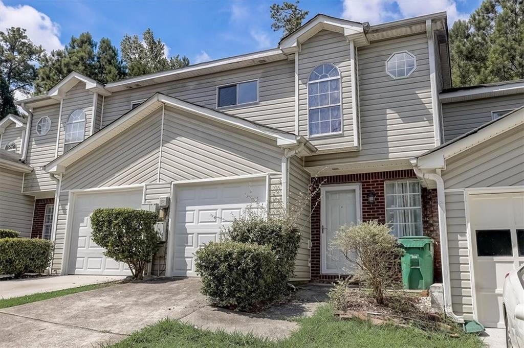 a view of a house with brick walls and potted plants
