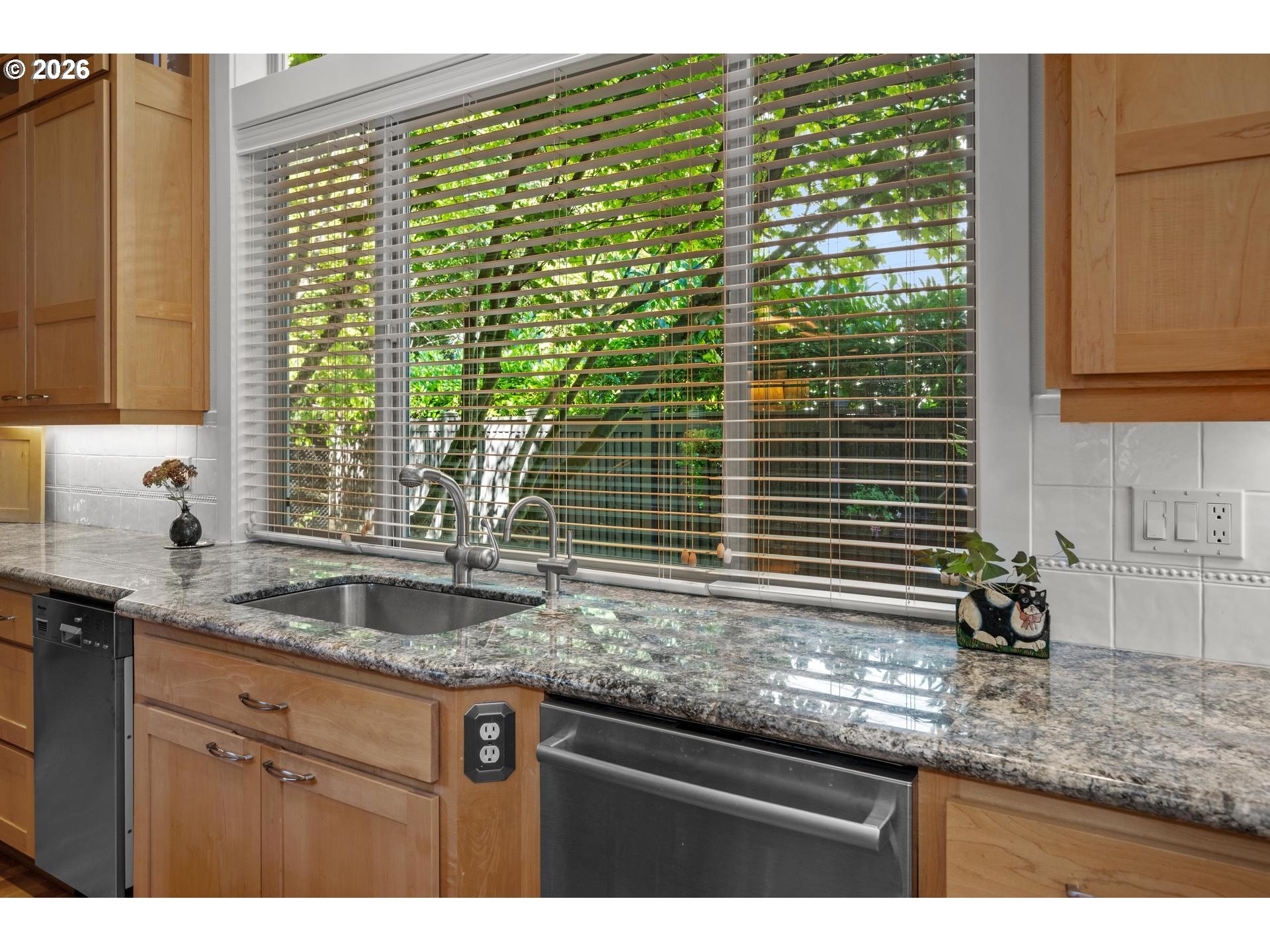 4217 Southwest 64th Court Portland, OR 97221 - Photo 18 of 48 a kitchen with granite countertop a sink and a window