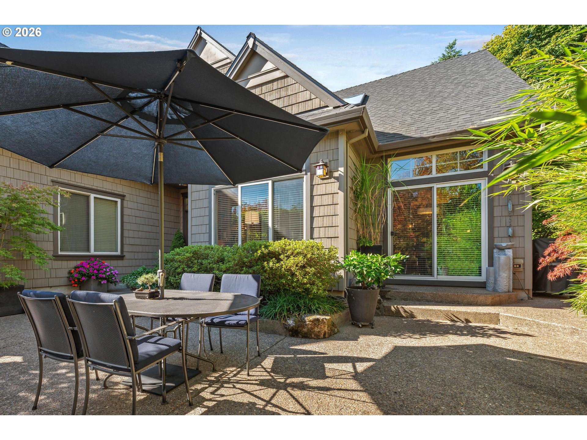 4217 Southwest 64th Court Portland, OR 97221 - Photo 44 of 48 a patio with a table and chairs and potted plants